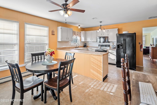 kitchen featuring decorative light fixtures, ceiling fan, black appliances, kitchen peninsula, and white cabinetry