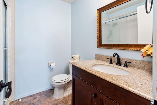 bathroom with toilet, a shower with door, and vanity