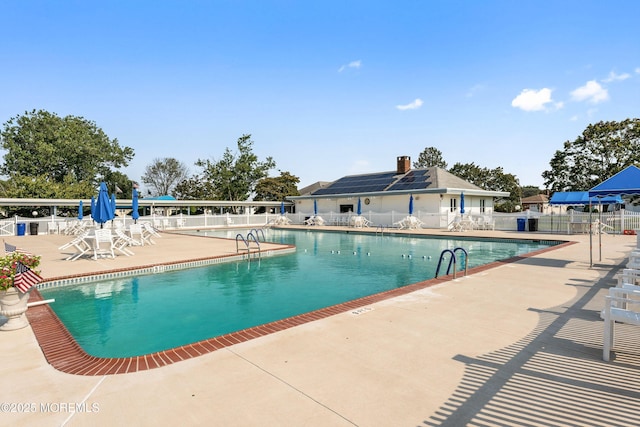 view of swimming pool with a patio area