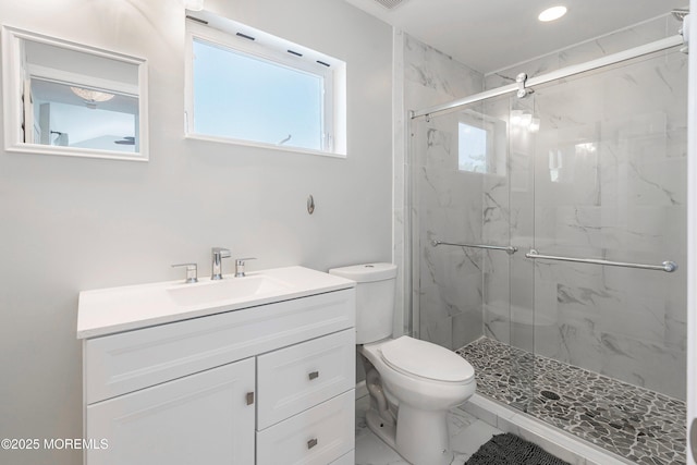 bathroom featuring toilet, walk in shower, and vanity