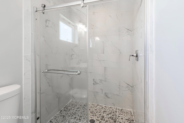 bathroom featuring toilet and an enclosed shower