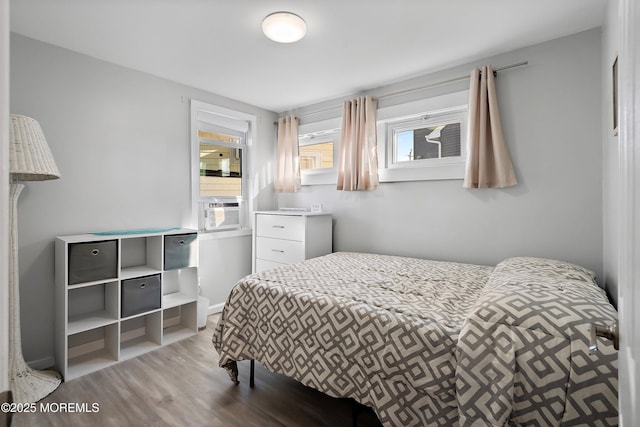 bedroom with wood-type flooring and cooling unit