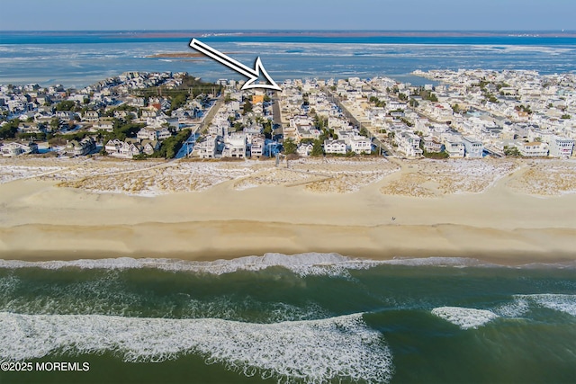 birds eye view of property with a beach view and a water view