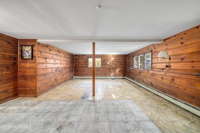 basement with wood walls and a baseboard heating unit