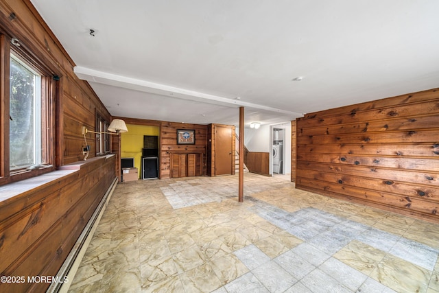 interior space featuring baseboard heating and wood walls