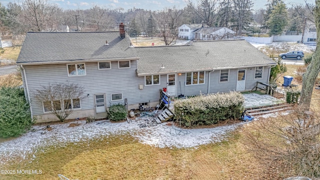 rear view of house featuring a yard and a wooden deck