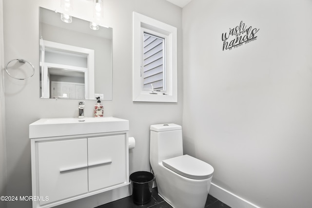 bathroom featuring tile patterned floors, vanity, and toilet