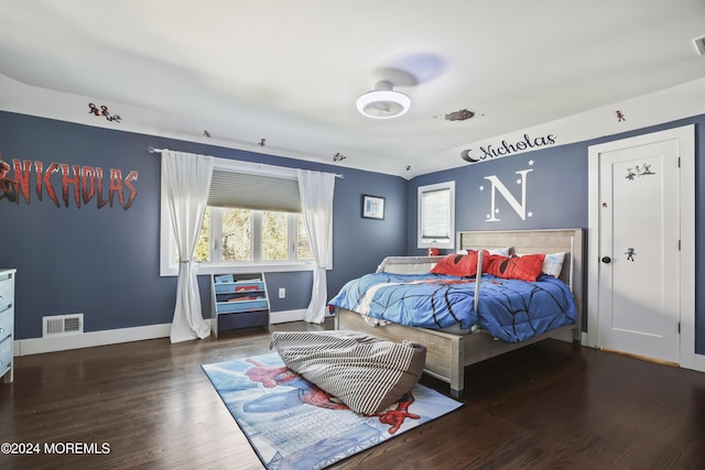 bedroom with dark hardwood / wood-style floors