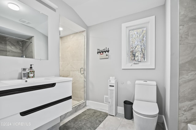 bathroom featuring vanity, vaulted ceiling, tile patterned flooring, toilet, and walk in shower