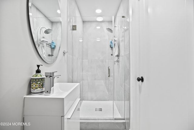 bathroom featuring vanity and a shower with shower door