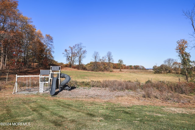 view of yard featuring a rural view and a playground