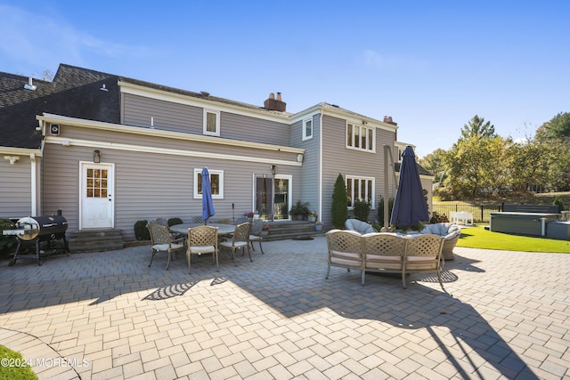 rear view of property featuring a patio and an outdoor hangout area