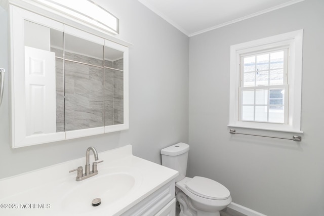 bathroom with vanity, toilet, and crown molding