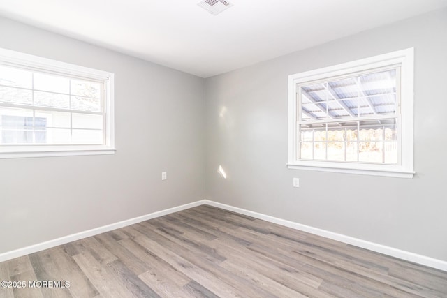 empty room with light hardwood / wood-style flooring