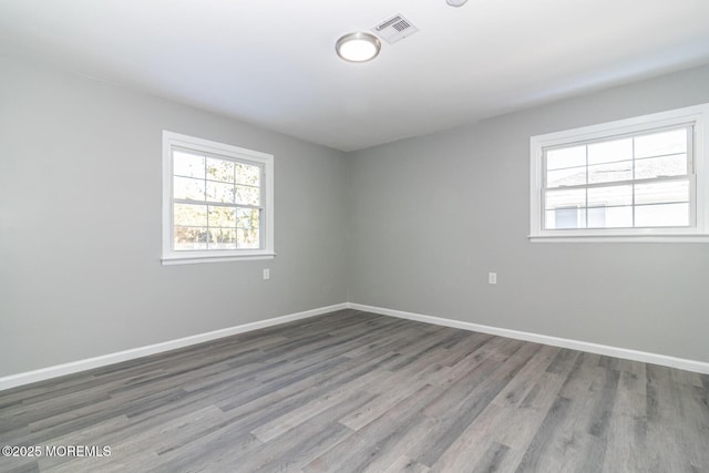 empty room with hardwood / wood-style flooring