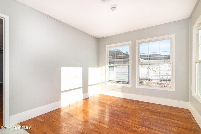 empty room with hardwood / wood-style flooring