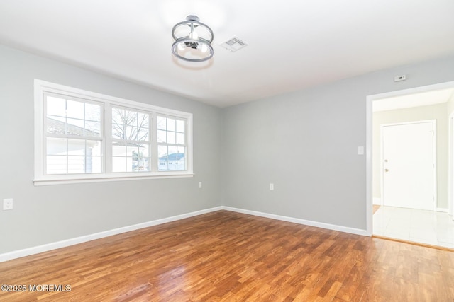 spare room featuring wood-type flooring