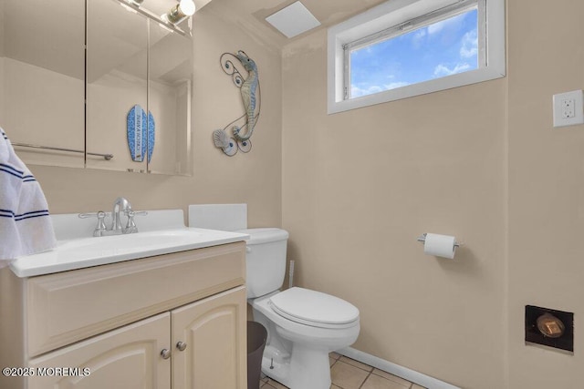 bathroom featuring toilet, vanity, and tile patterned floors