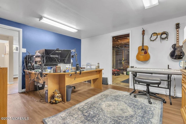 office featuring a workshop area and light hardwood / wood-style flooring