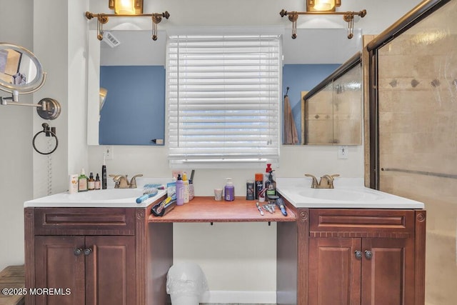 bathroom with a shower with shower door and vanity