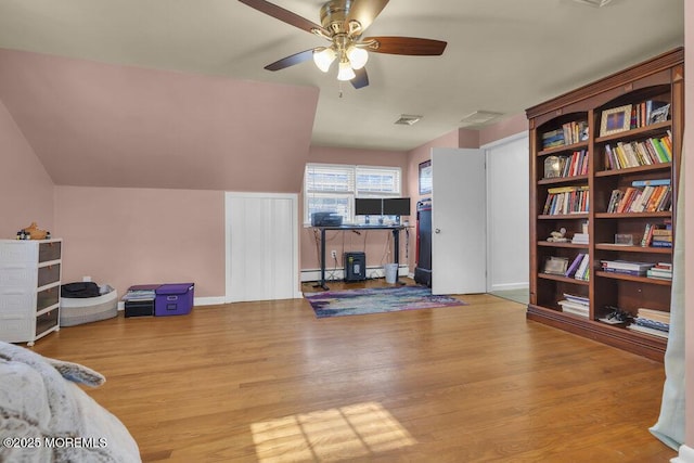 interior space featuring ceiling fan, baseboard heating, and light wood-type flooring