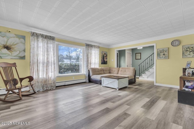 living room featuring a baseboard heating unit, crown molding, and light hardwood / wood-style flooring