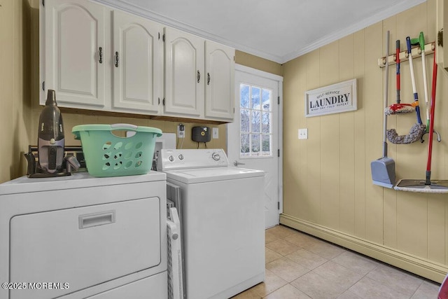 laundry area with washer and clothes dryer, cabinets, a baseboard heating unit, ornamental molding, and light tile patterned floors