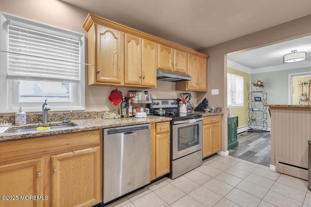 kitchen featuring light tile patterned floors, appliances with stainless steel finishes, plenty of natural light, light stone countertops, and sink