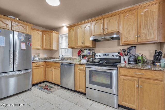 kitchen with light stone countertops, sink, appliances with stainless steel finishes, and light tile patterned flooring