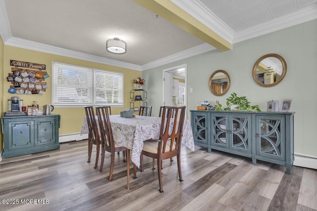 dining room featuring crown molding, light hardwood / wood-style floors, and a baseboard radiator