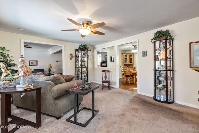 living room with ceiling fan and light colored carpet