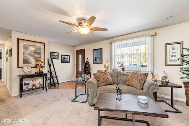 carpeted living room with ceiling fan