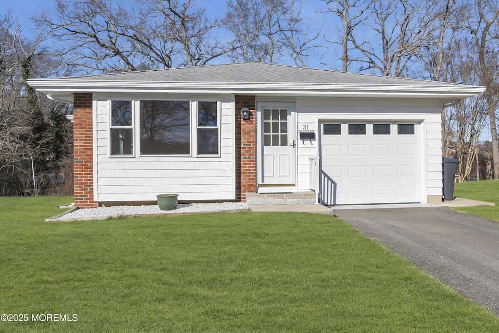 single story home featuring a front lawn and a garage