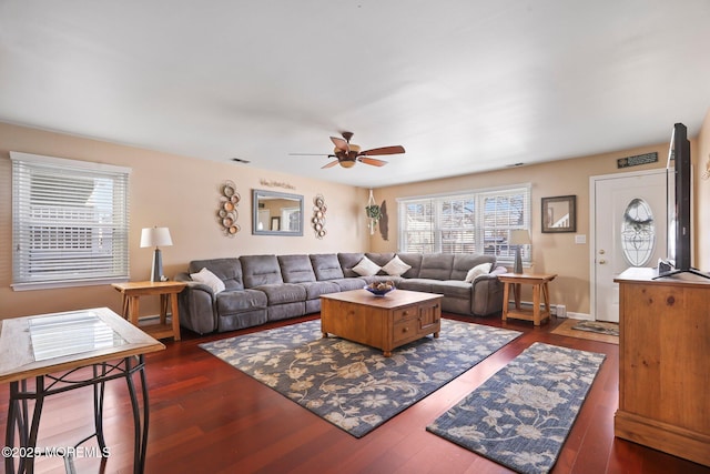 living room with ceiling fan and dark hardwood / wood-style flooring