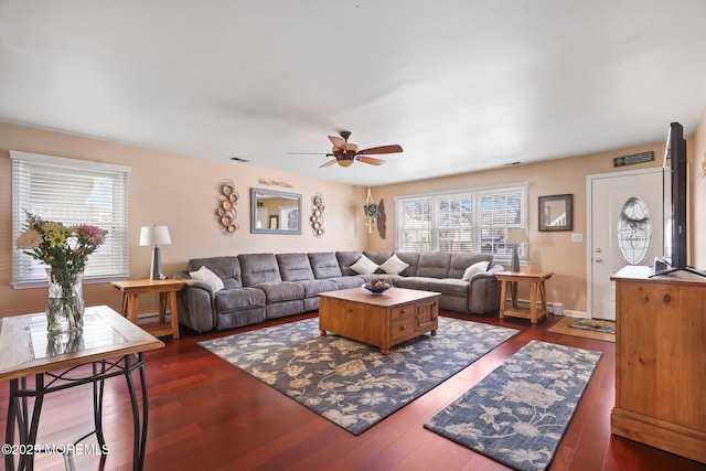 living room featuring dark hardwood / wood-style flooring and ceiling fan