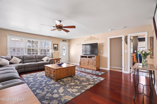 living room with dark hardwood / wood-style flooring and ceiling fan