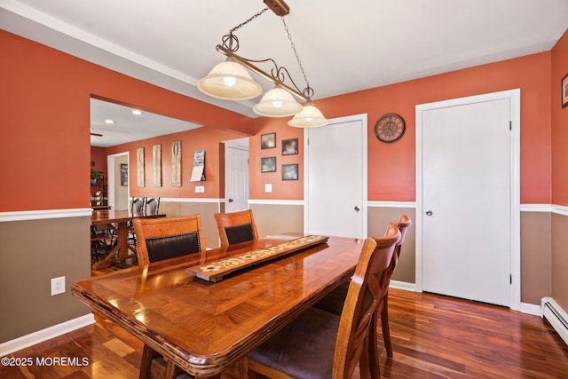 dining space featuring dark hardwood / wood-style flooring and a baseboard radiator