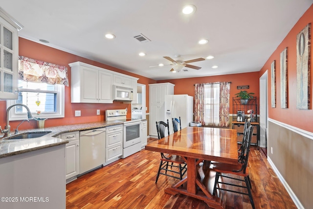 kitchen featuring white appliances, white cabinetry, sink, and wood-type flooring