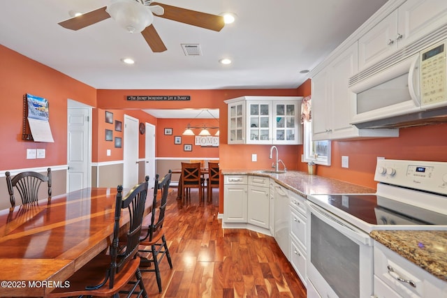 kitchen featuring white appliances, dark wood-type flooring, white cabinetry, and sink