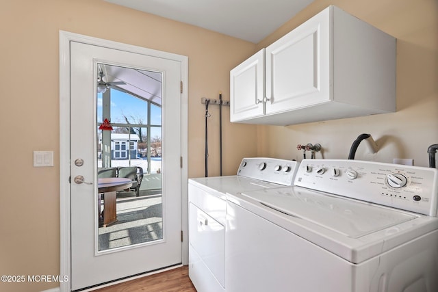 clothes washing area with ceiling fan, light hardwood / wood-style flooring, cabinets, and washing machine and clothes dryer