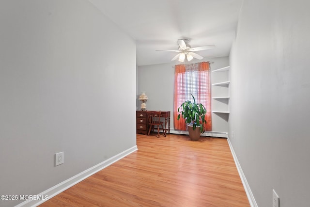 unfurnished room with a baseboard radiator, ceiling fan, and light hardwood / wood-style flooring