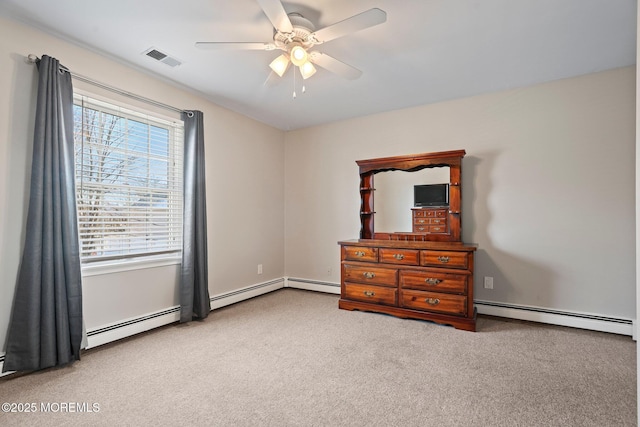 bedroom with ceiling fan, baseboard heating, and carpet