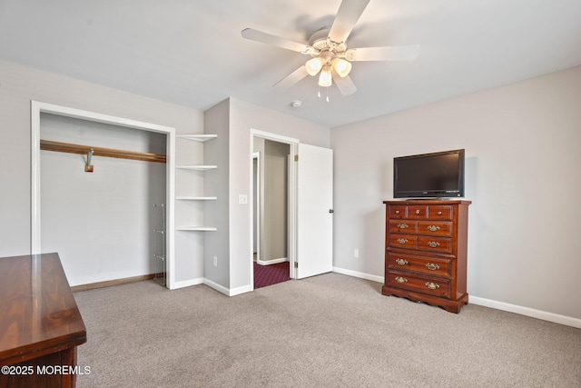 unfurnished bedroom featuring ceiling fan, a closet, and light carpet