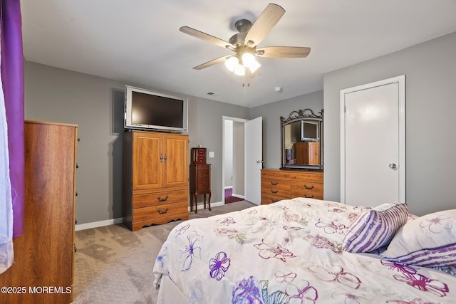 bedroom with ceiling fan and light carpet