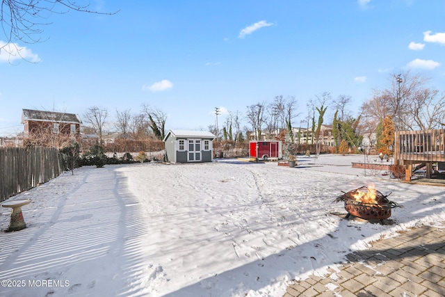 view of yard featuring a fire pit and a storage unit