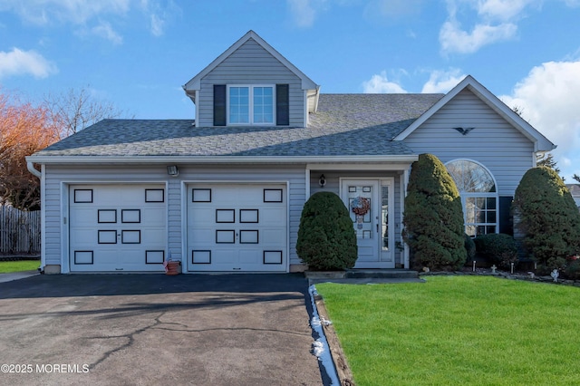 view of front of house featuring a front yard and a garage