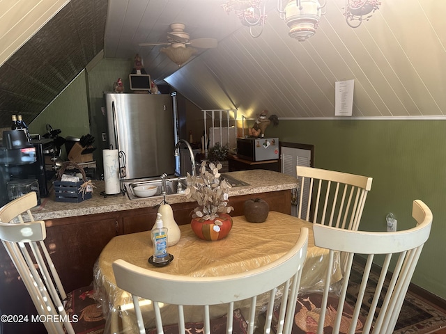 dining space featuring vaulted ceiling, ceiling fan, and sink