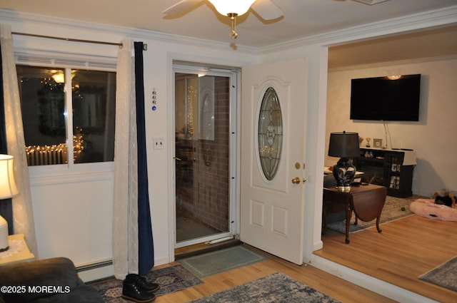 interior space with ceiling fan and a baseboard heating unit