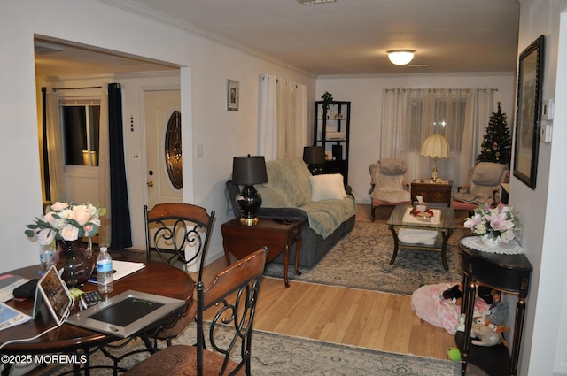 living room featuring hardwood / wood-style floors and ornamental molding