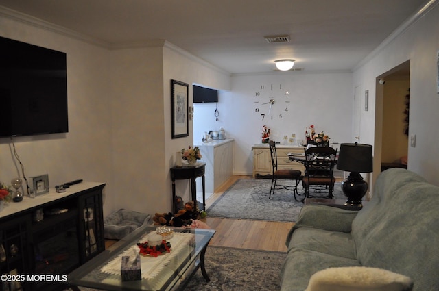 living room featuring wood-type flooring and ornamental molding